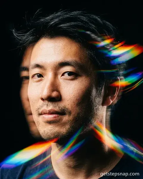 A close headshot of a man with streaks of rainbow light from a prism across his face. Made by GetStepSnap with Nano Banana 2.1.