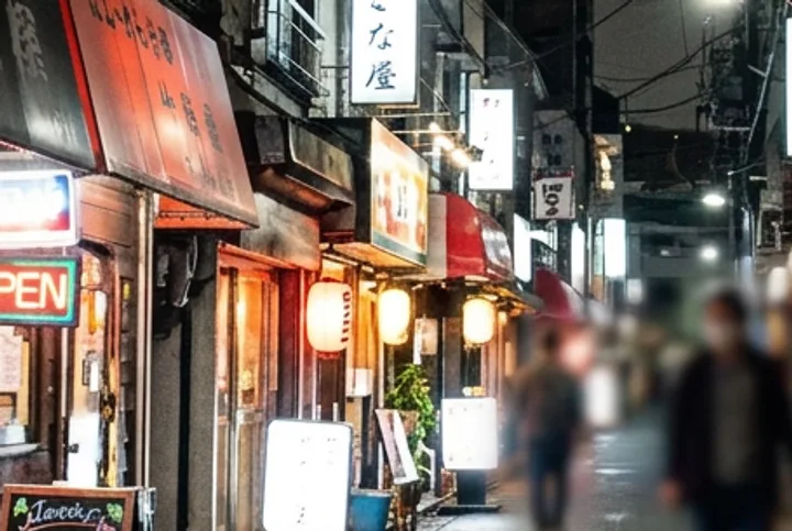 The same shop fronts and lanterns in the cleaned-up photo, smooth and sharp