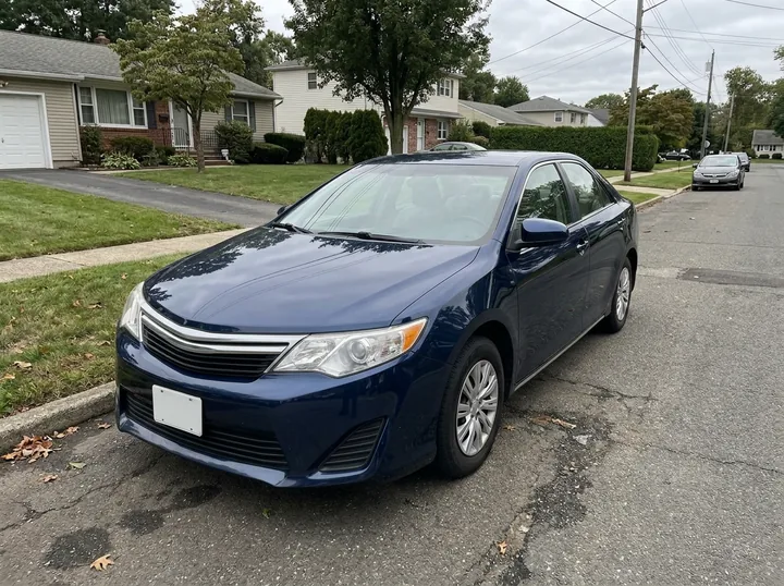 The same sedan repainted metallic midnight blue on the same street