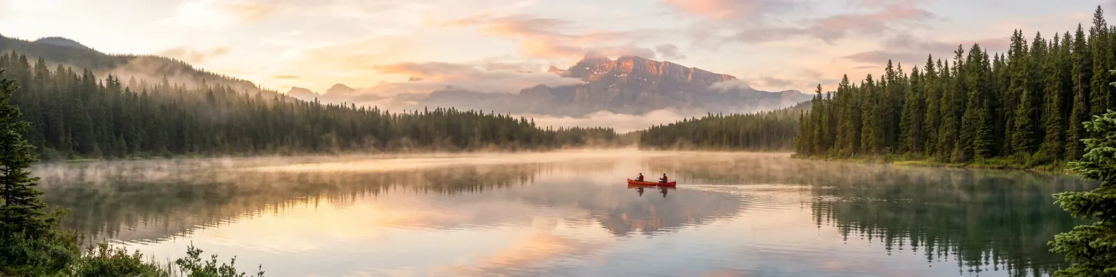 A 4:1 panorama of a misty mountain lake at sunrise with a red canoe, made with Nano Banana 2.1