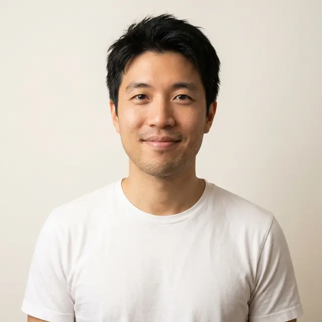 A team-page headshot of the man in a white t-shirt on an off-white background