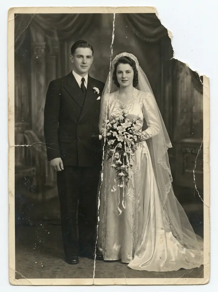 A worn 1940s black-and-white wedding portrait with a torn corner and a crease down the middle (made with the model)